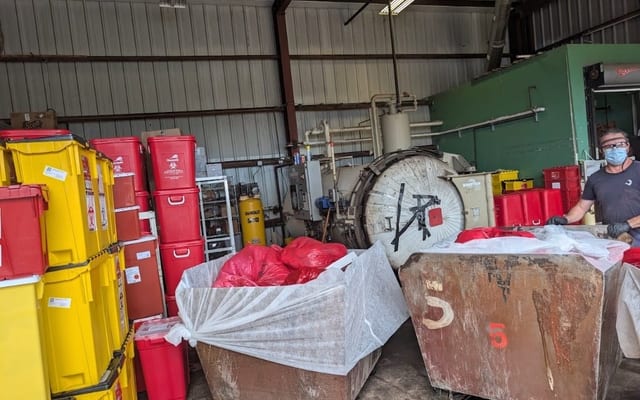 Medical waste management team handling compliant disposal