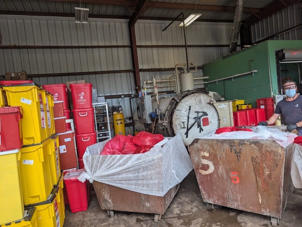 Medical waste management team handling compliant disposal